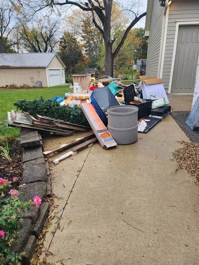 Dumpster being loaded with debris for Commercial Dumpster Rental in Rowlett